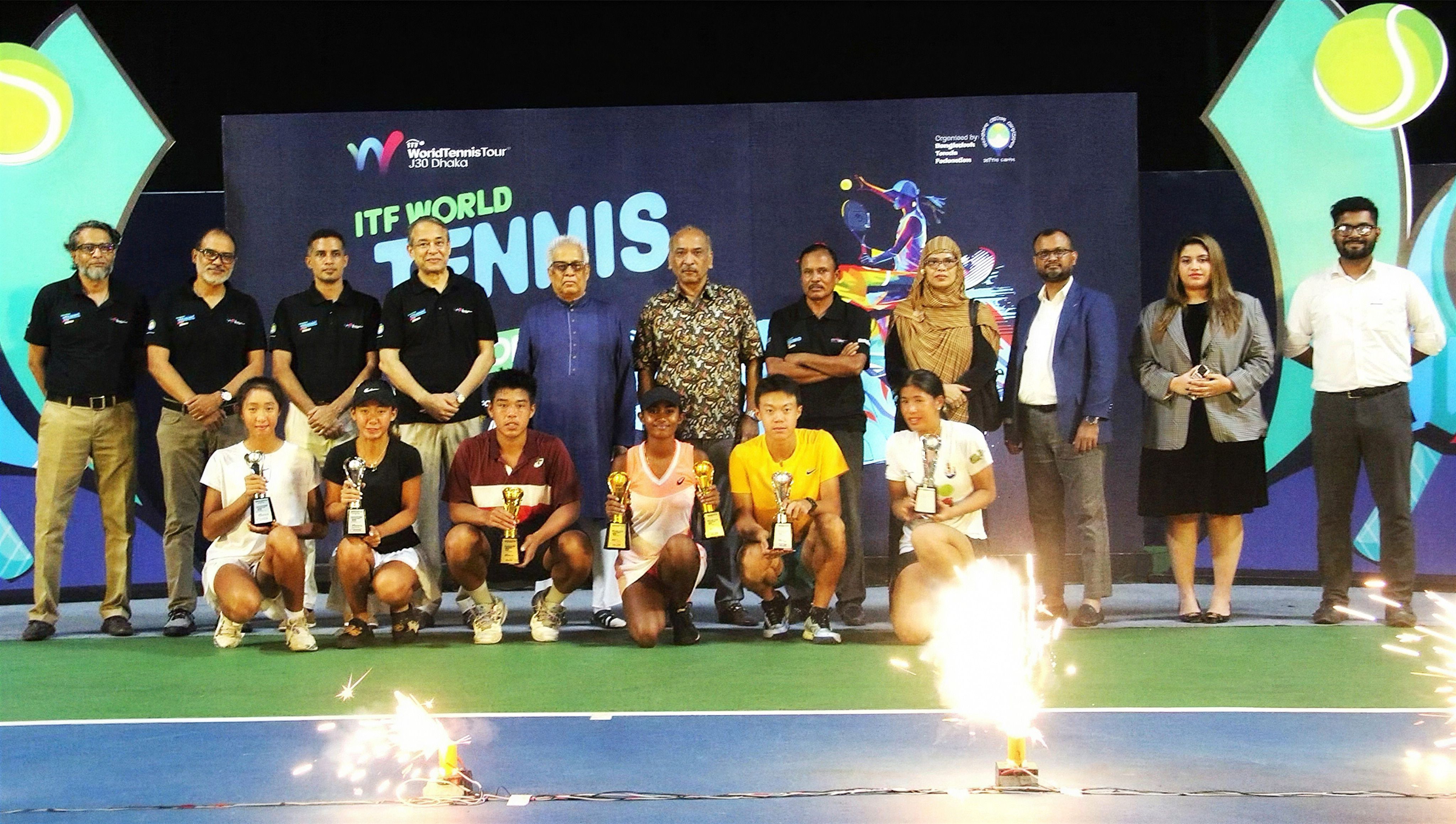 J30 Dhaka closing-stage group photo with officials, players, and pyrotechnics.