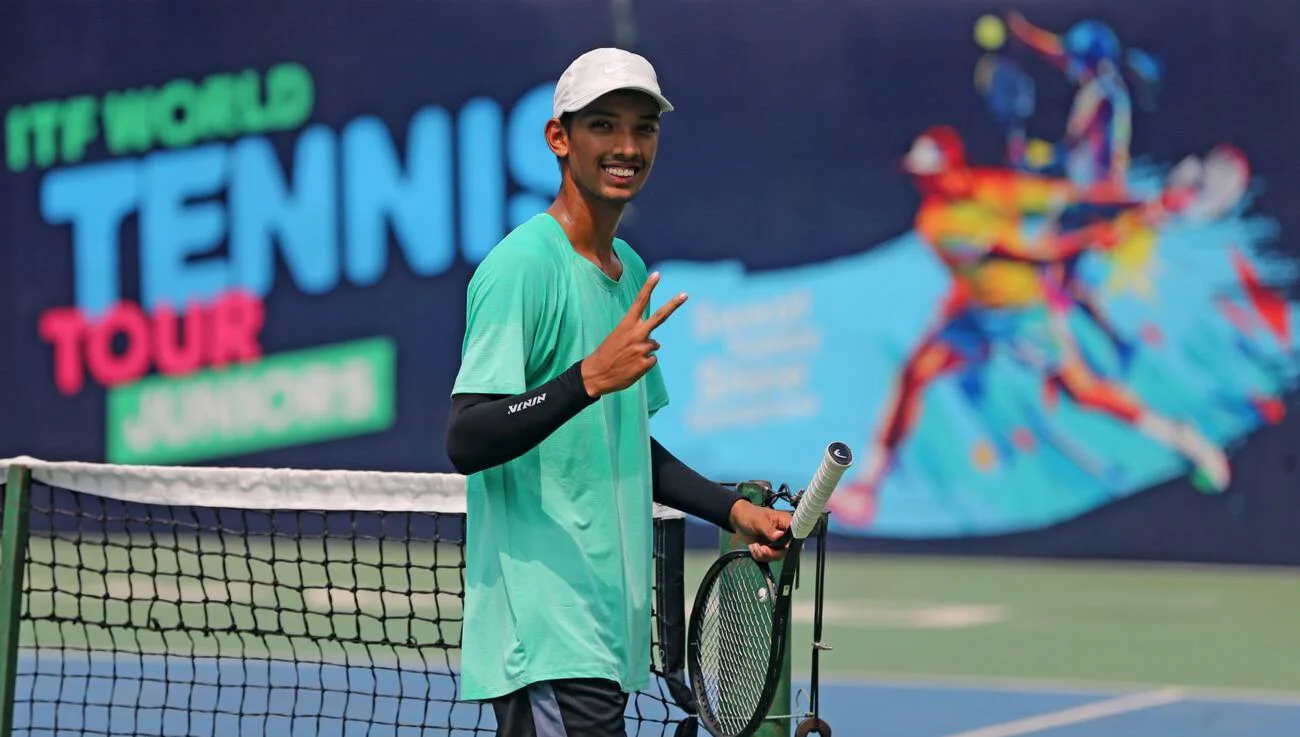 Tennis player posing on court at the J30 Dhaka tournament venue.